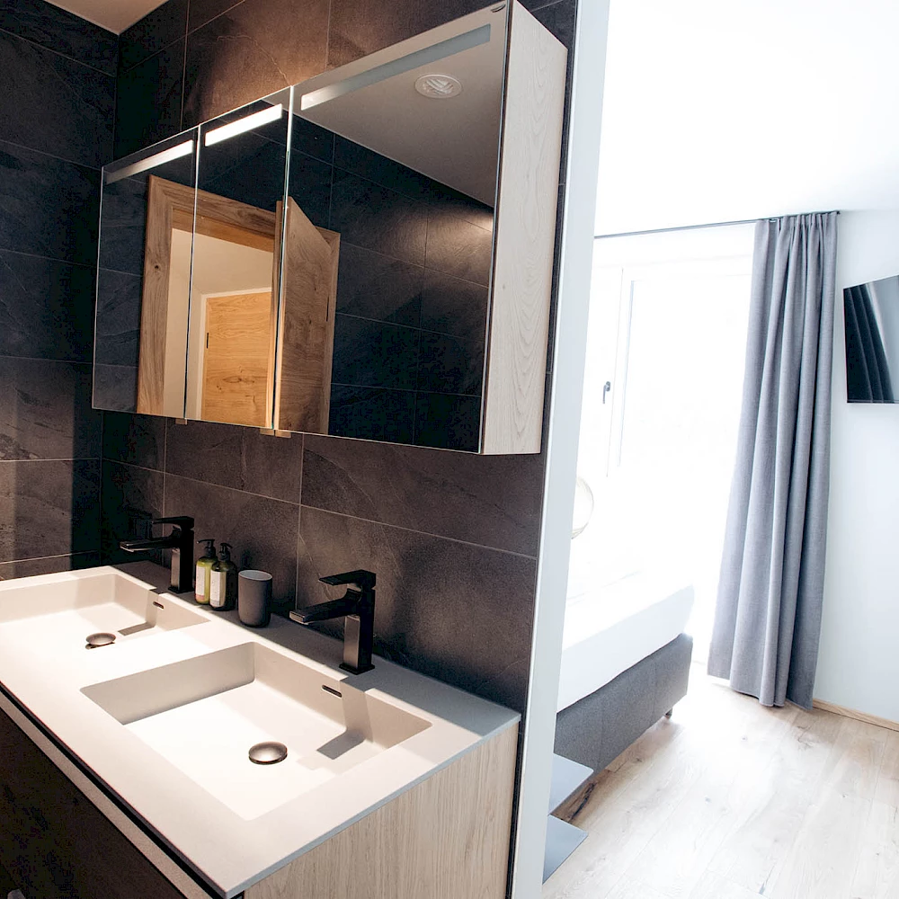 Bathroom and toilets are en suite in the Adler Chalet Ischgl.